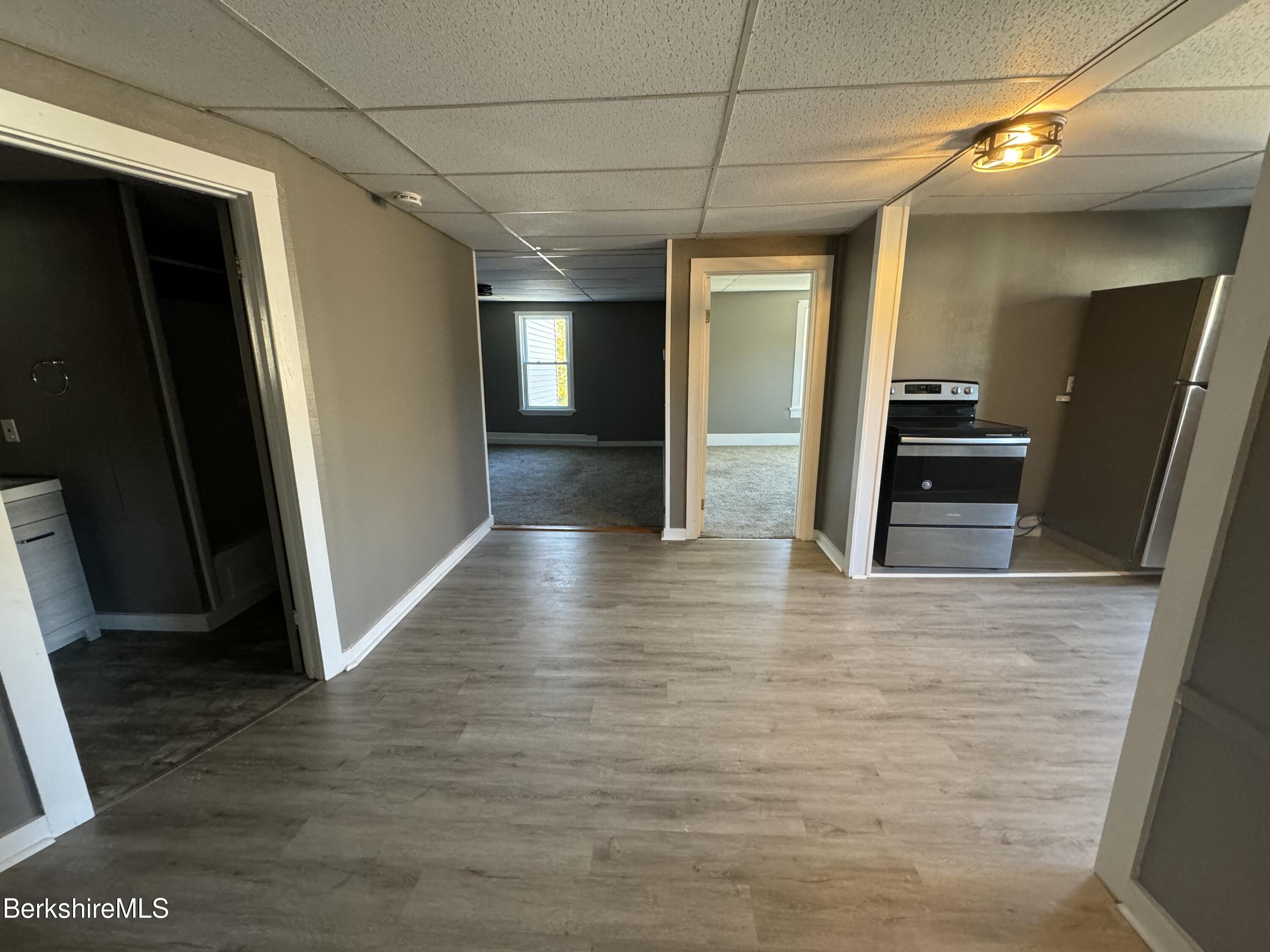 88 Summer Street, Unit 3C Adams, MA 01220 - Photo 3 of 11 a view of a hallway with wooden floor and staircase