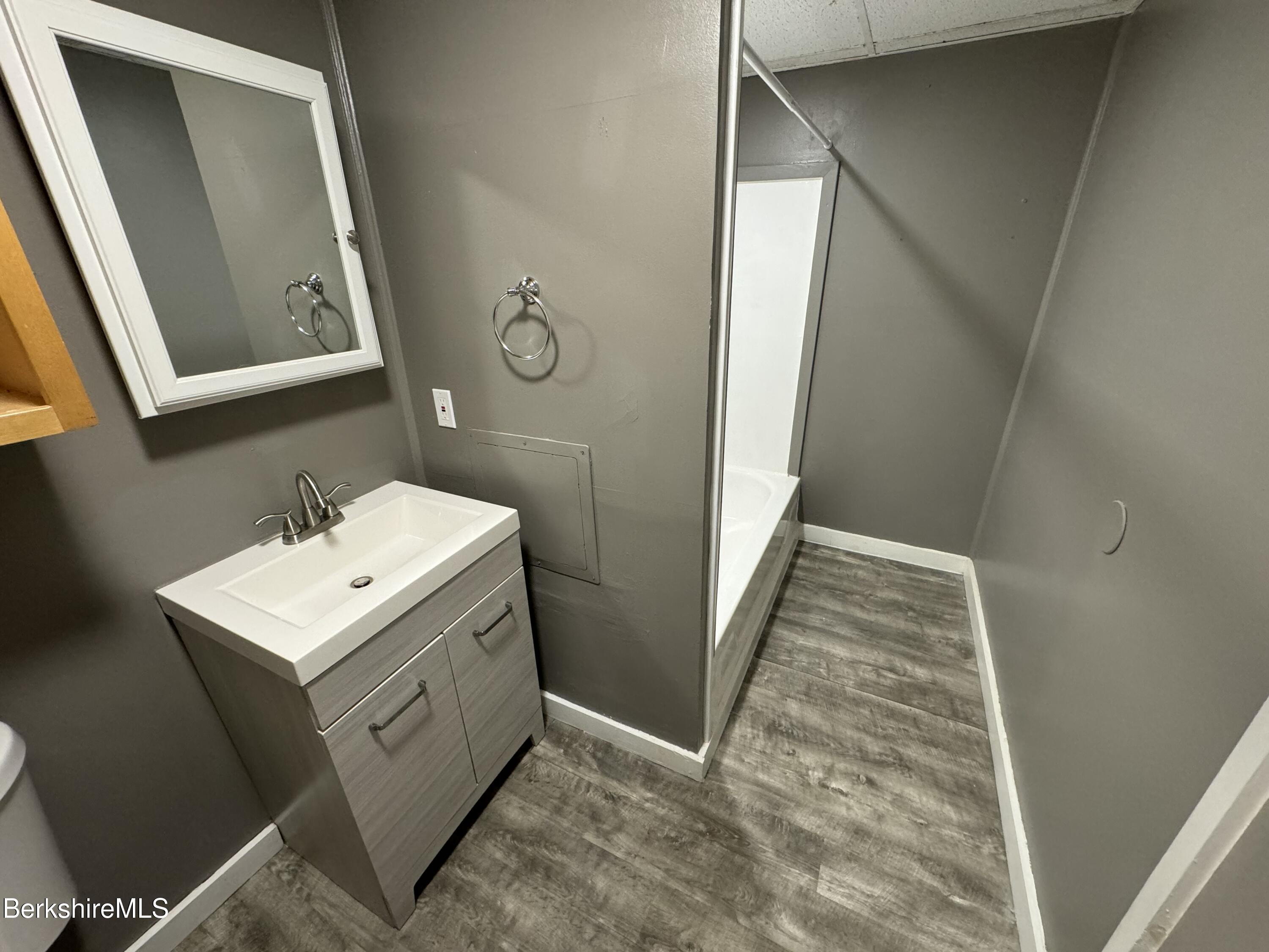 88 Summer Street, Unit 3C Adams, MA 01220 - Photo 5 of 11 a bathroom with a sink and mirror with toilet