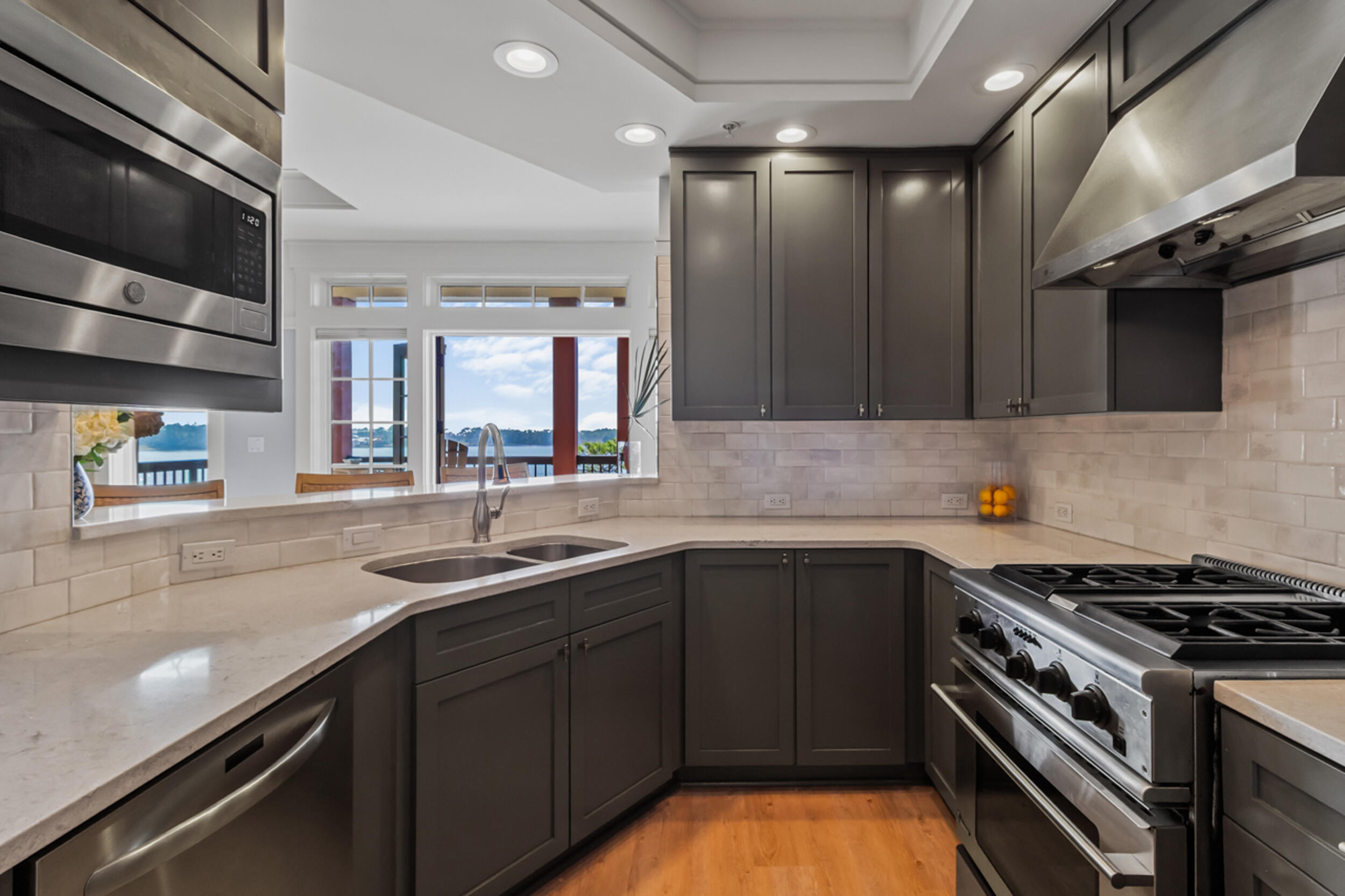 1101 Prospect Promenade, Unit 403 Panama City Beach, FL 32413 - Photo 11 of 74 a kitchen that has a sink and a stove