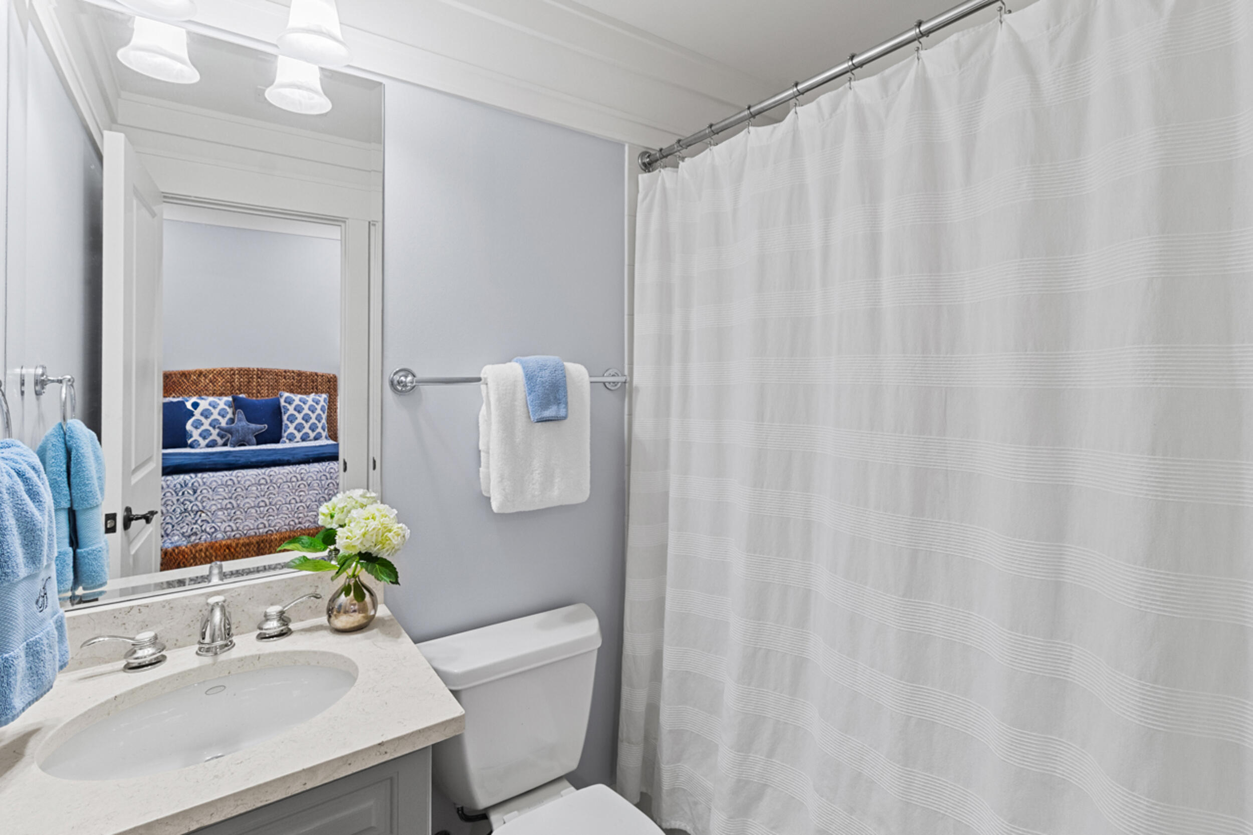 1101 Prospect Promenade, Unit 403 Panama City Beach, FL 32413 - Photo 24 of 74 a bath room with a sink a toilet and a mirror