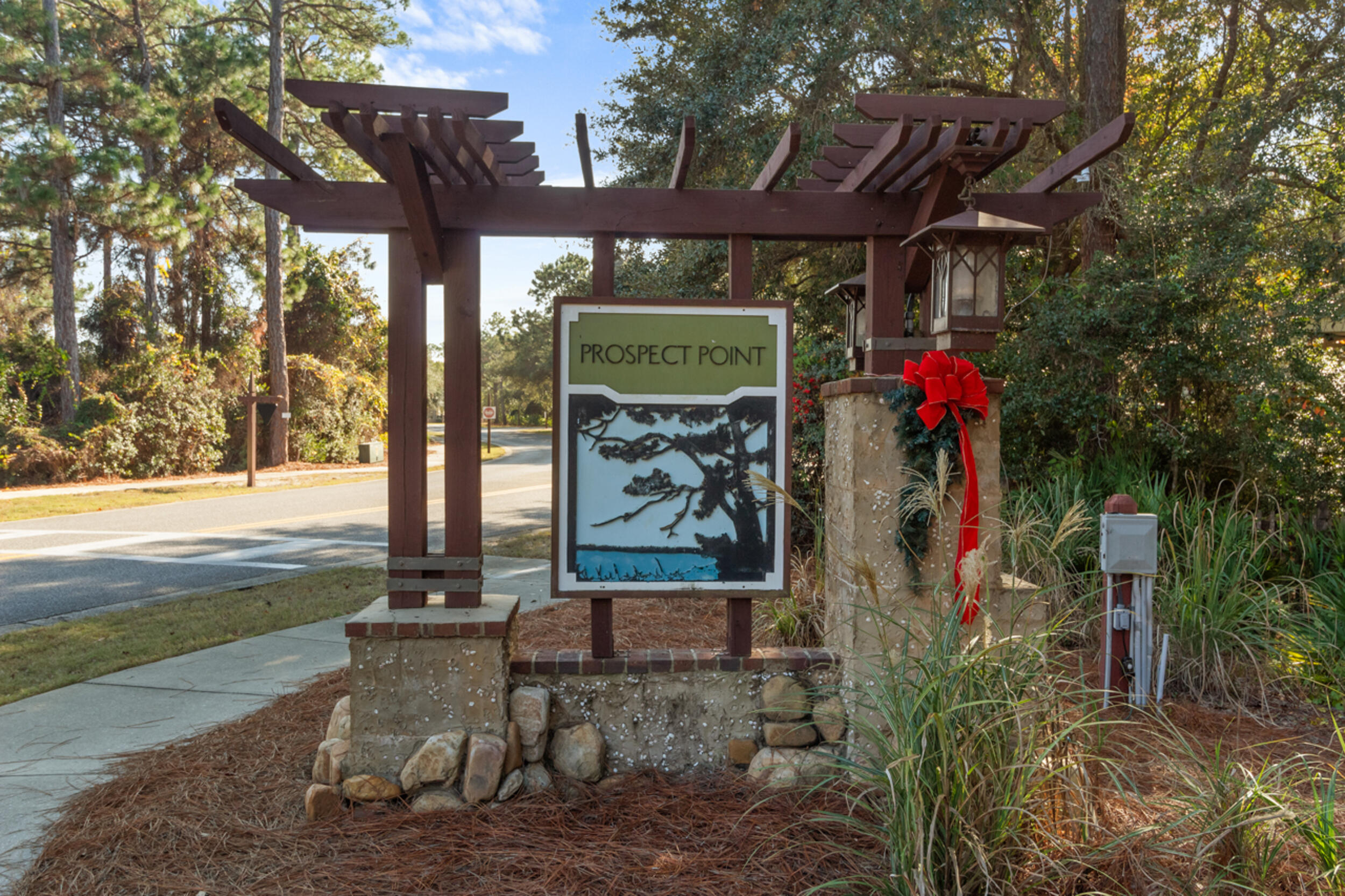1101 Prospect Promenade, Unit 403 Panama City Beach, FL 32413 - Photo 69 of 74 a view of a bench in a garden