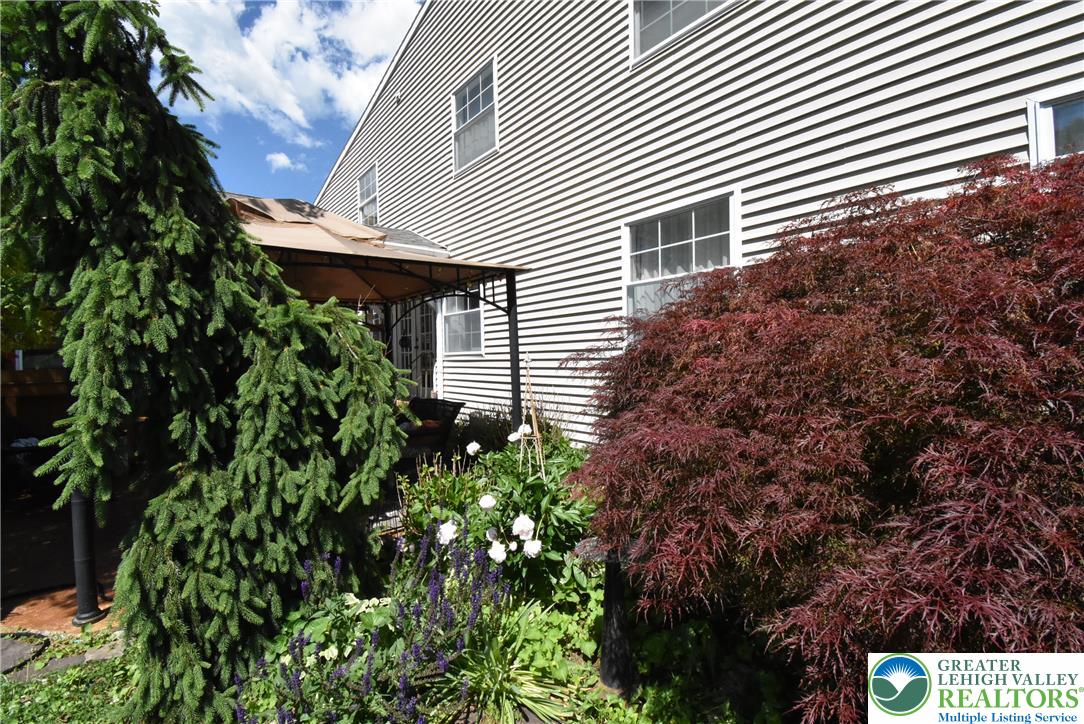 424 Grape Street Whitehall, PA 18052 - Photo 55 of 56 Mature landscaping with vibrant foliage frames the inviting side of this residence.