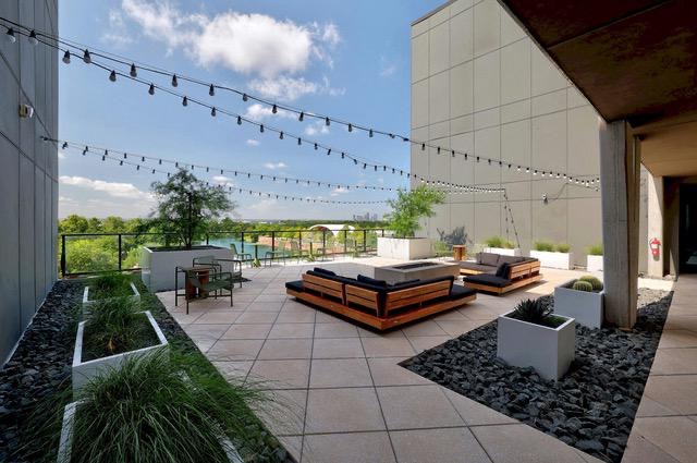 1701 Simond Avenue, Unit 615 Austin, TX 78723 - Photo 15 of 25 Rooftop patio with string lighting, paver flooring, and a stone fire pit