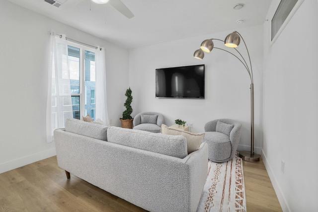 1701 Simond Avenue, Unit 615 Austin, TX 78723 - Photo 10 of 25 Bright living area featuring wood-finish flooring and a ceiling fan