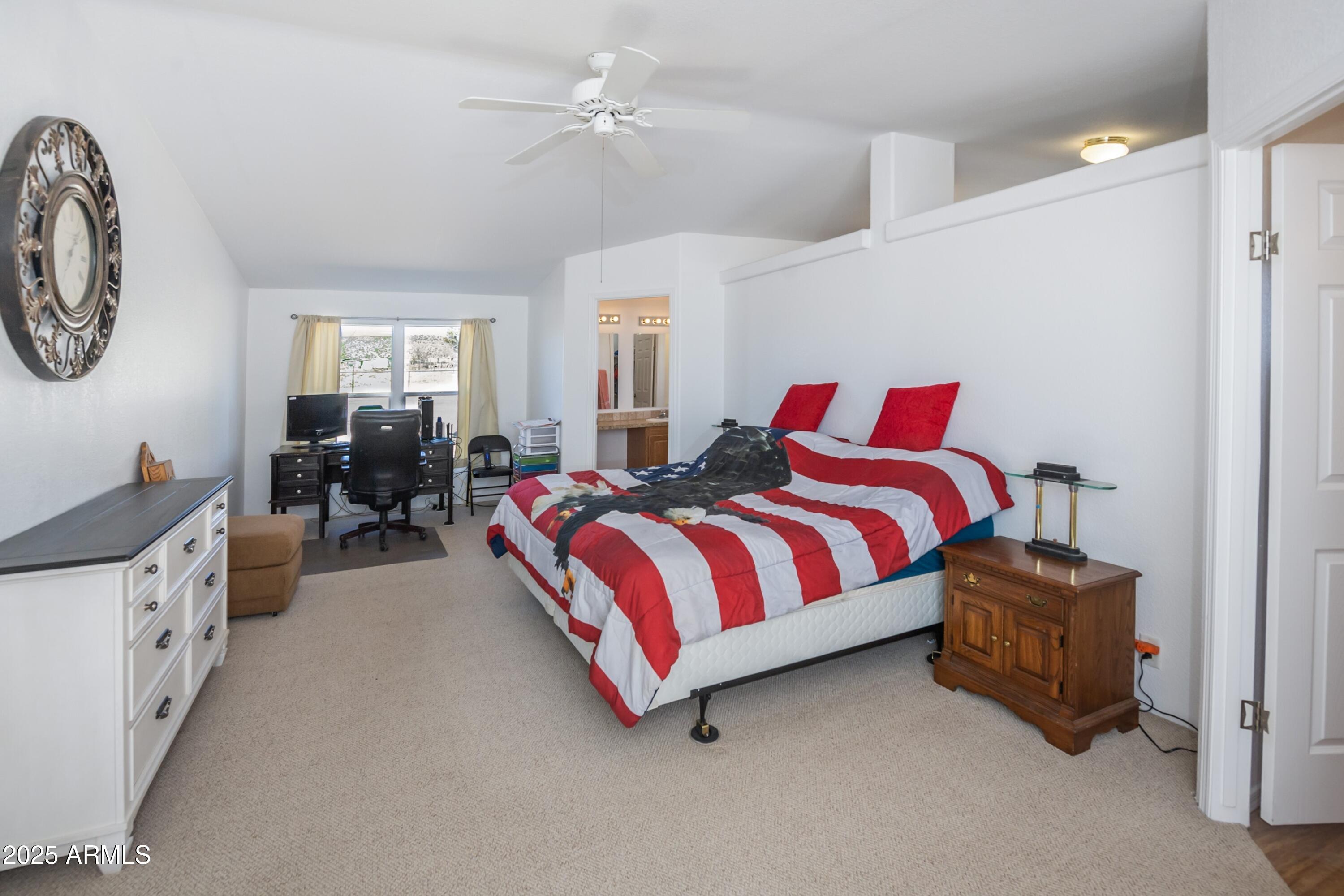 255 West Antelope Run Road Paulden, AZ 86334 - Photo 10 of 26 a spacious bedroom with a bed couch and a window
