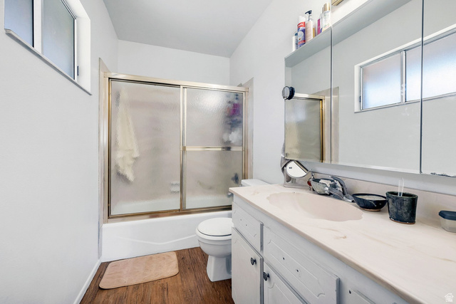 3334 Ute Road St. George, UT 84790 - Photo 22 of 40 Bathroom with vanity, shower / bath combination with glass door, and dark wood-type flooring