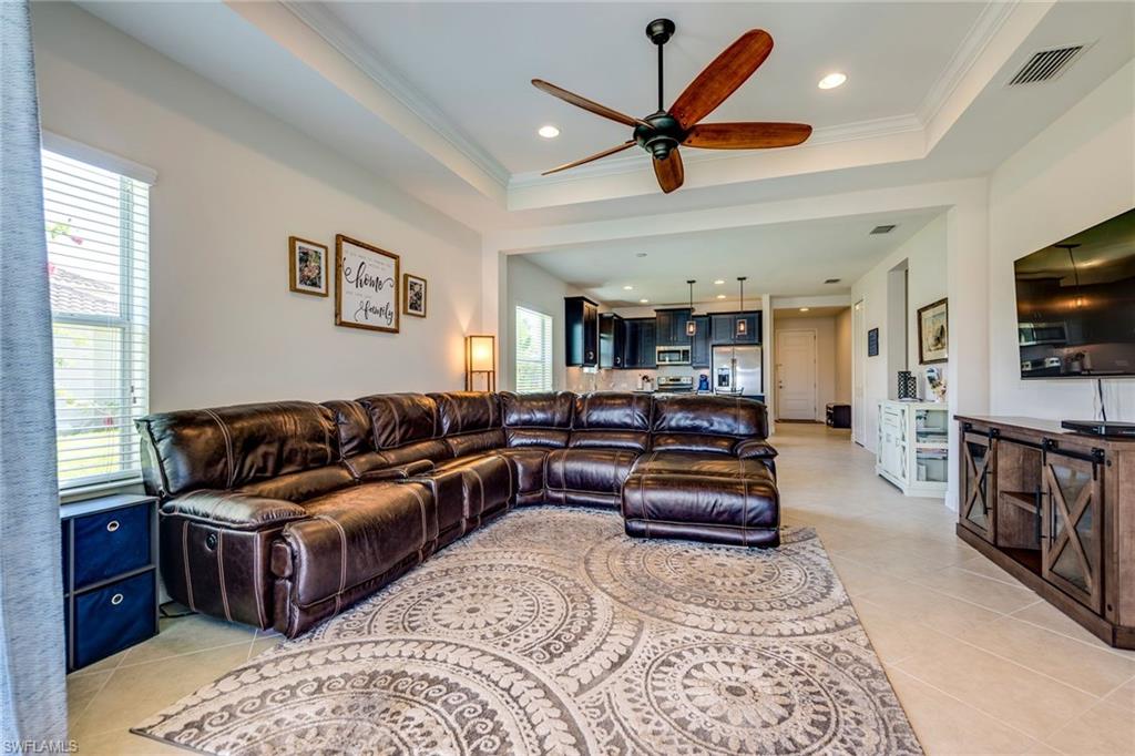 3782 Canopy Circle Naples, FL 34120 - Photo 12 of 31 a living room with furniture and a flat screen tv