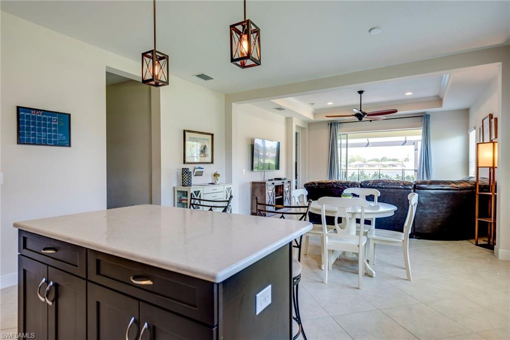 3782 Canopy Circle Naples, FL 34120 - Photo 17 of 31 a view of kitchen island and dining room