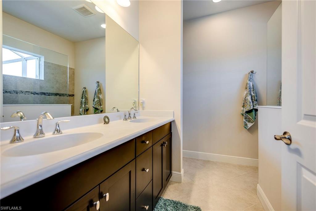 3782 Canopy Circle Naples, FL 34120 - Photo 21 of 31 a bathroom with a double vanity sink a and mirror