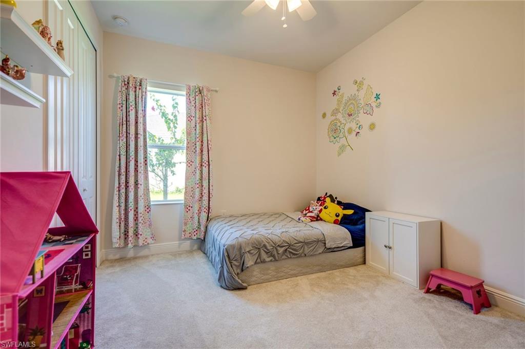 3782 Canopy Circle Naples, FL 34120 - Photo 23 of 31 a bedroom with a bed and a window