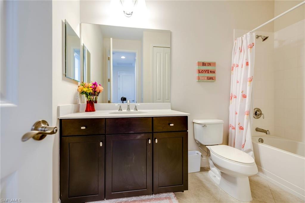 3782 Canopy Circle Naples, FL 34120 - Photo 24 of 31 a bathroom with a sink vanity mirror and toilet