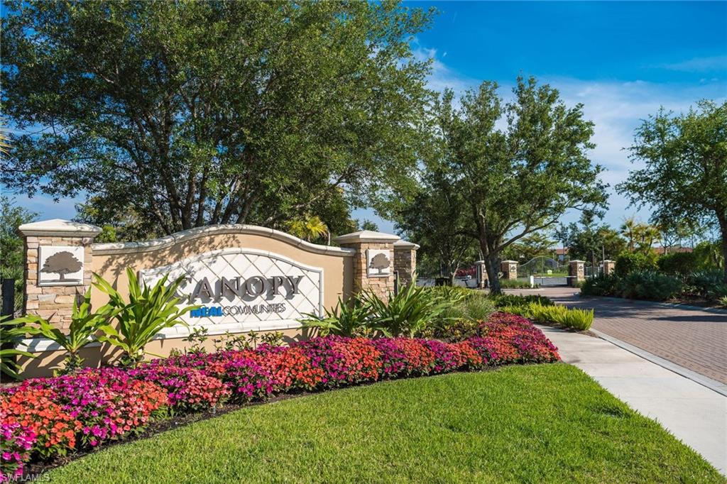 3782 Canopy Circle Naples, FL 34120 - Photo 31 of 31 a view of street with flower plants and large trees