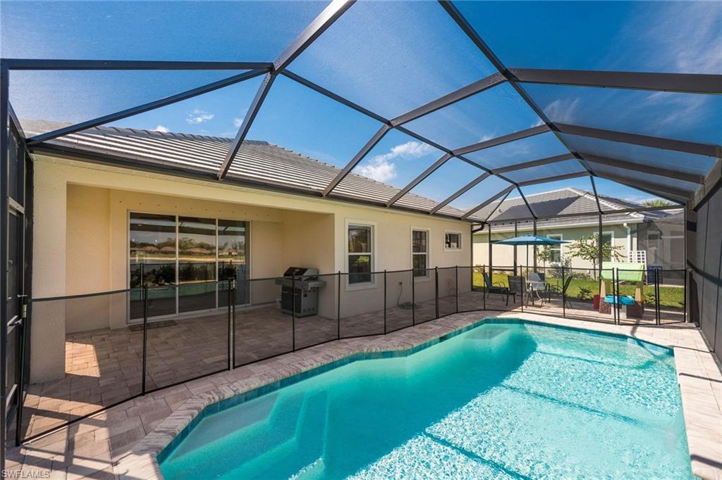 3782 Canopy Circle Naples, FL 34120 - Photo 7 of 31 a view of a backyard with a patio and a garden
