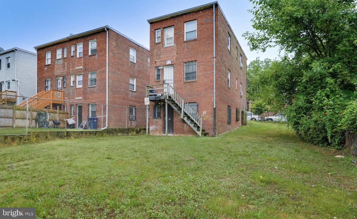 341 54th Street Northeast Washington, DC 20019 - Photo 2 of 16 a view of a brick house with a yard and plants