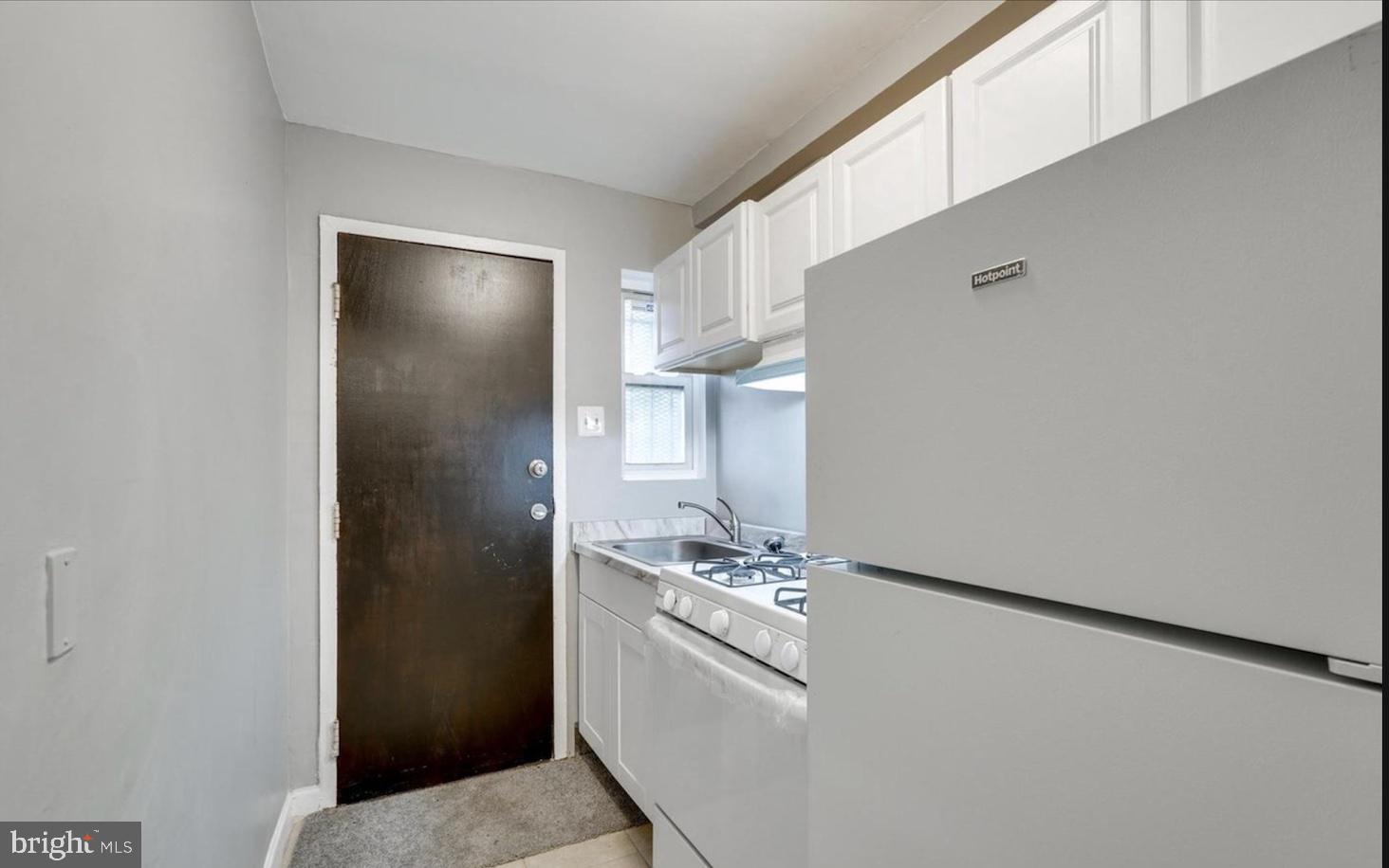 341 54th Street Northeast Washington, DC 20019 - Photo 9 of 16 a kitchen with a refrigerator and washer