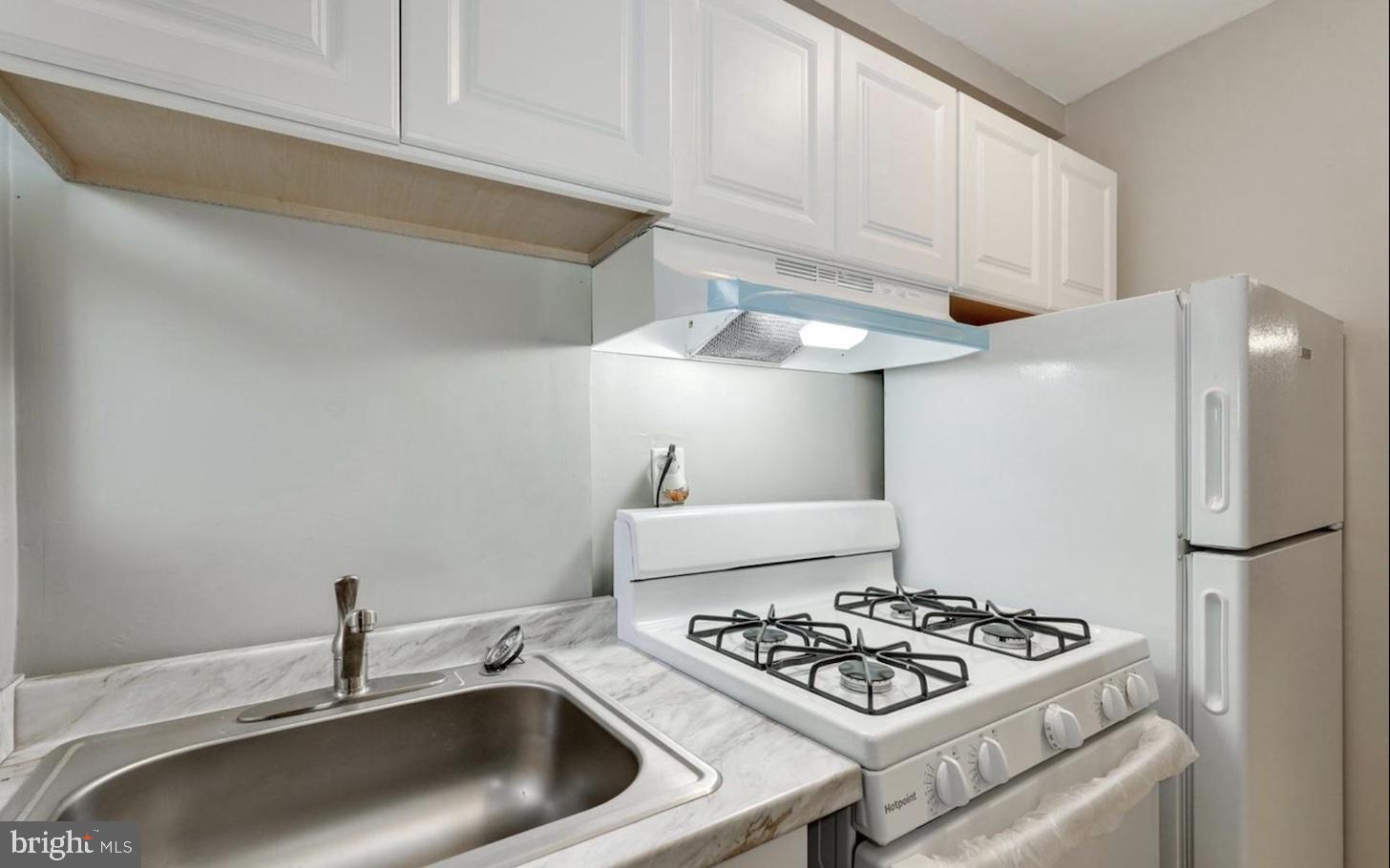 341 54th Street Northeast Washington, DC 20019 - Photo 10 of 16 a kitchen with stainless steel appliances granite countertop a sink stove and refrigerator