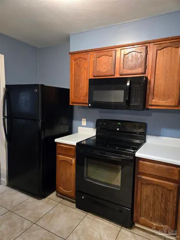 a kitchen with granite countertop cabinets and steel stainless steel appliances