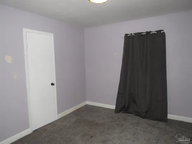 an empty room with a wooden door