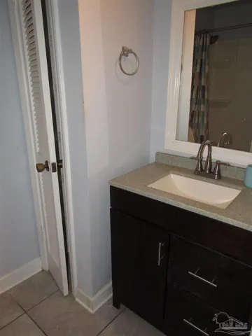 a bathroom with a sink vanity and a mirror