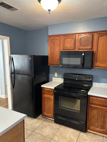 a kitchen with a refrigerator stove and microwave
