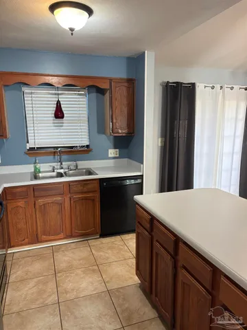 a kitchen with stainless steel appliances a sink stove and refrigerator