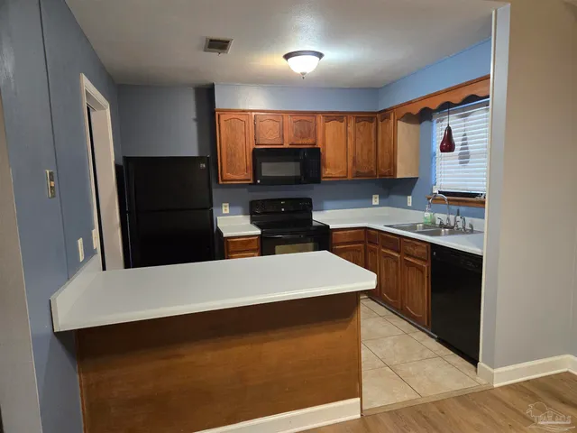 a kitchen with a sink a stove and refrigerator