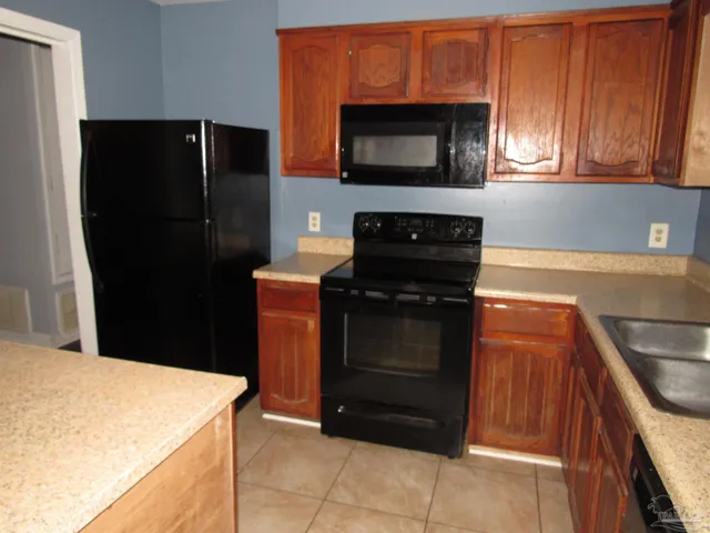 a kitchen with a refrigerator stove and microwave