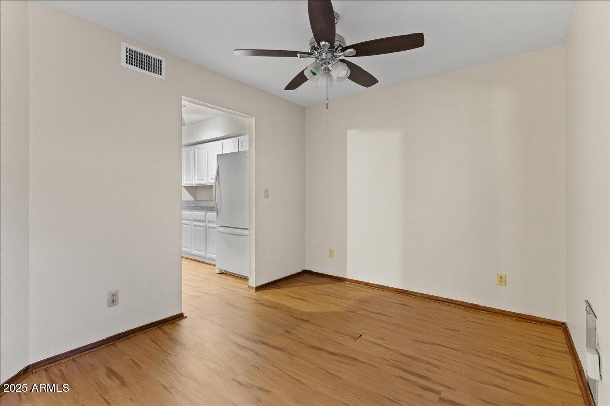 5750 North 10th Street, Unit 5 Phoenix, AZ 85014 - Photo 15 of 37 a view of an empty room with window and wooden floor