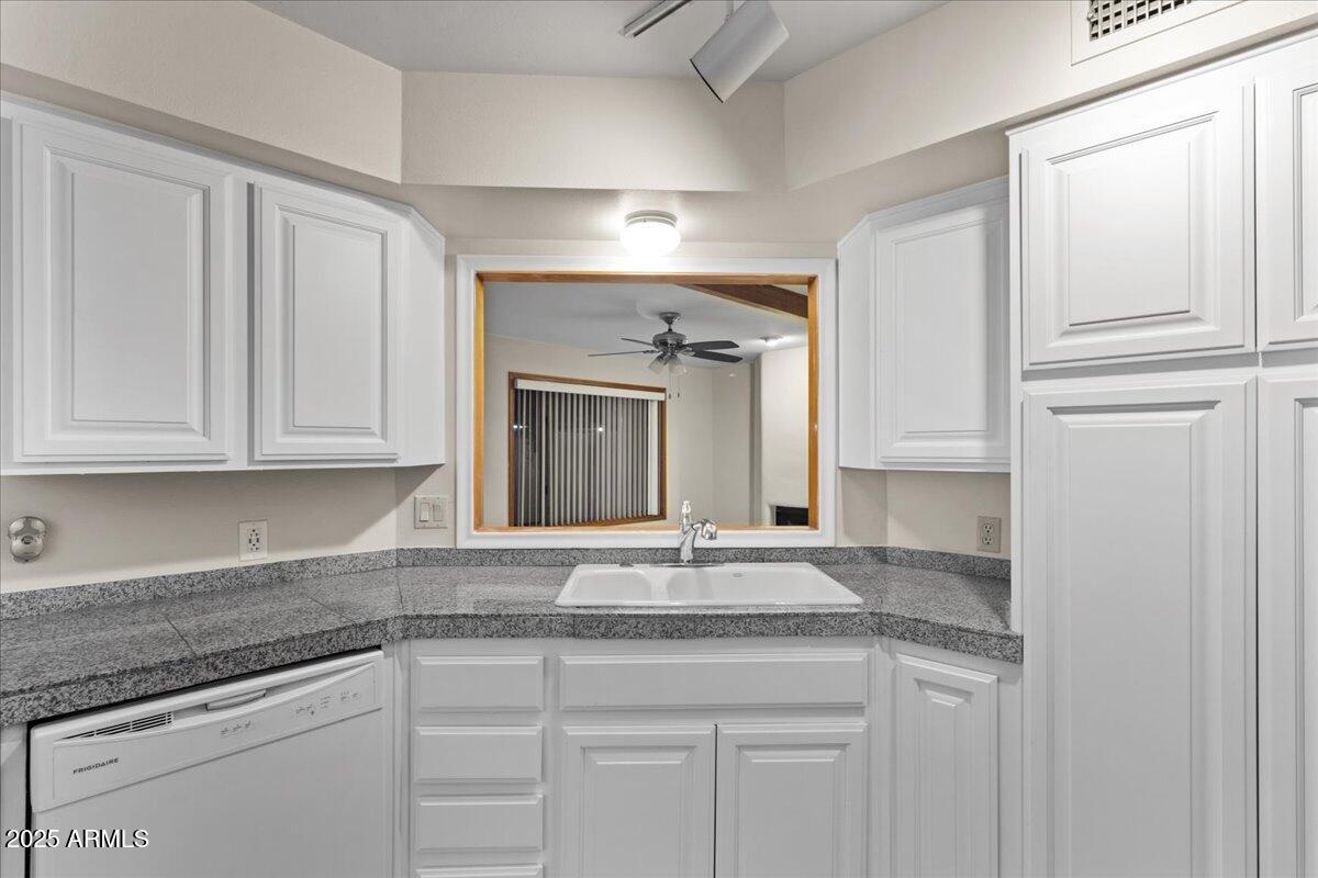 5750 North 10th Street, Unit 5 Phoenix, AZ 85014 - Photo 19 of 37 a kitchen with granite countertop cabinets and granite counter tops