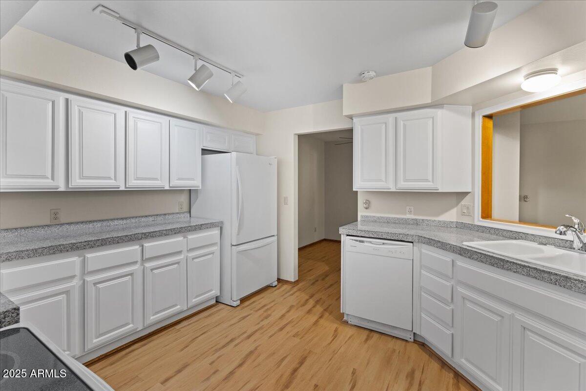5750 North 10th Street, Unit 5 Phoenix, AZ 85014 - Photo 20 of 37 a kitchen with granite countertop white cabinets and white appliances