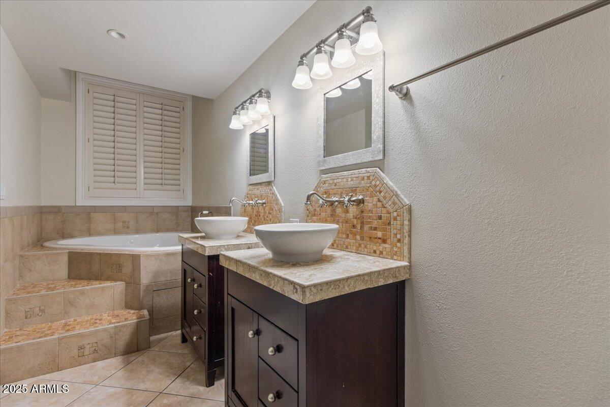 5750 North 10th Street, Unit 5 Phoenix, AZ 85014 - Photo 26 of 37 a bathroom with a granite countertop sink a toilet and bathtub