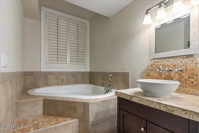 a white bath tub sitting next to a white toilet