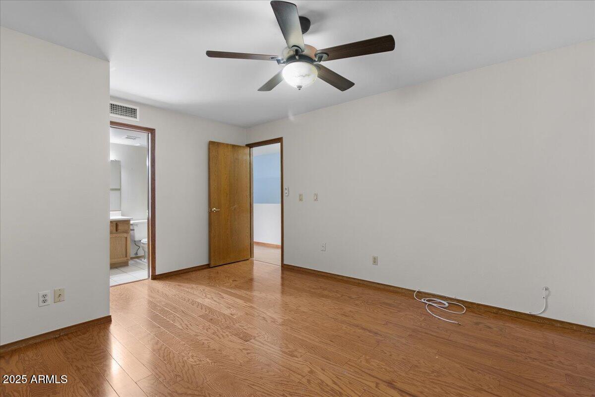 5750 North 10th Street, Unit 5 Phoenix, AZ 85014 - Photo 32 of 37 a view of an empty room with wooden floor