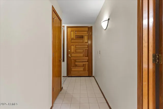 a view of a hallway with closet and bathroom