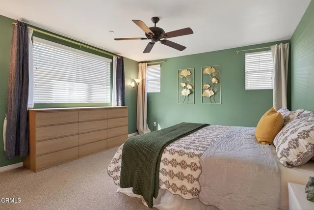 a bedroom with a large bed and a window