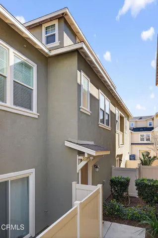 a front view of a house with plants
