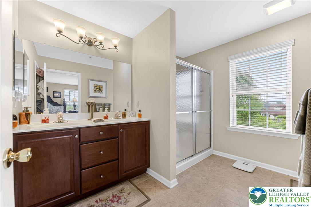 5440 Spring Ridge Drive West Macungie, PA 18062 - Photo 21 of 40 Well-lit bathroom with a spacious vanity and a walk-in shower.