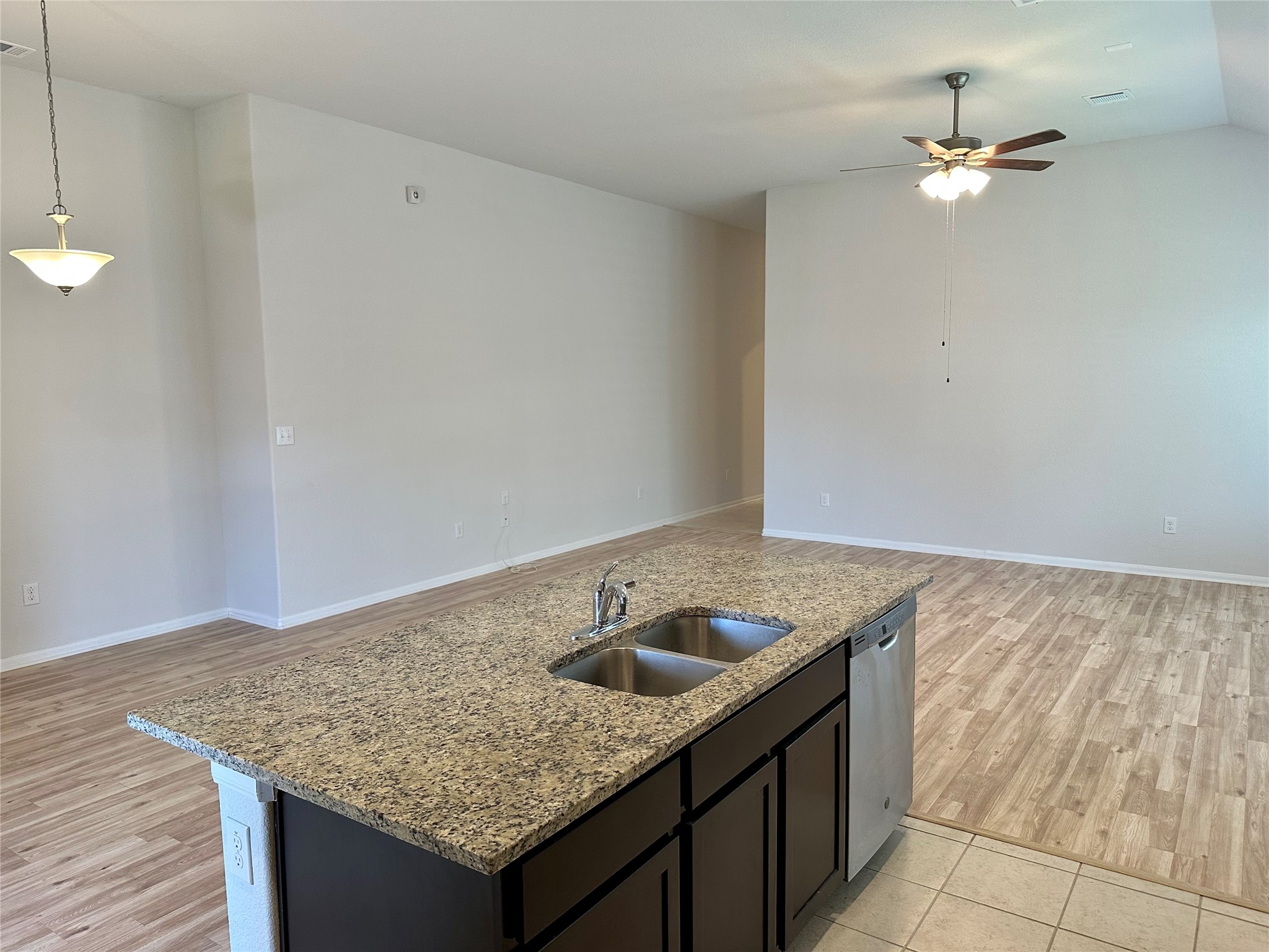 1003 Cherrystone Loop Buda, TX 78610 - Photo 7 of 27 a kitchen with granite countertop a sink and a stove