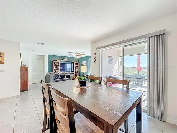 a view of a dining room with furniture and a potted plant
