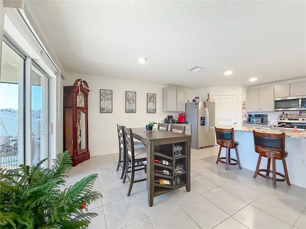 a living room with furniture a flat screen tv and a window