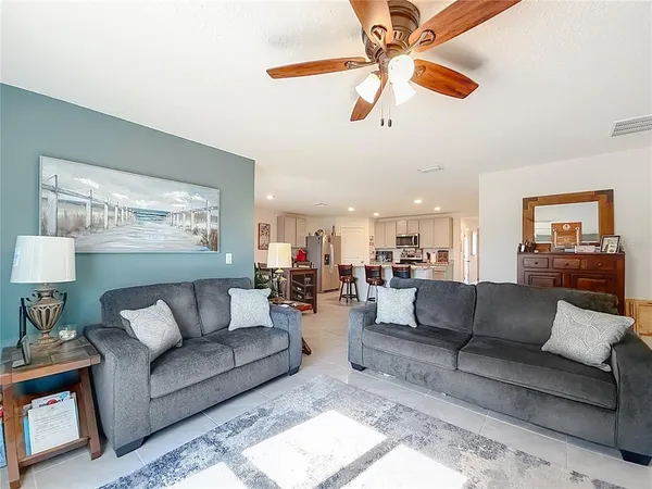 a bedroom with a bed and a flat tv screen on dresser