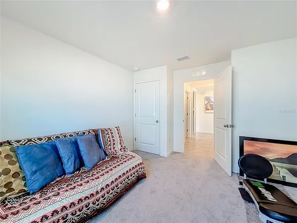 a bed sitting in a bedroom next to a window