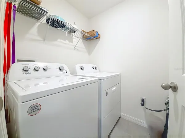 a living room with furniture a rug and white walls