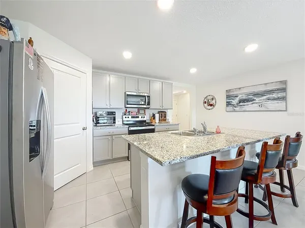 a kitchen with refrigerator and cabinets