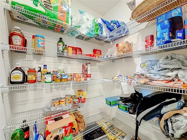 a kitchen with a dining table chairs and white appliances