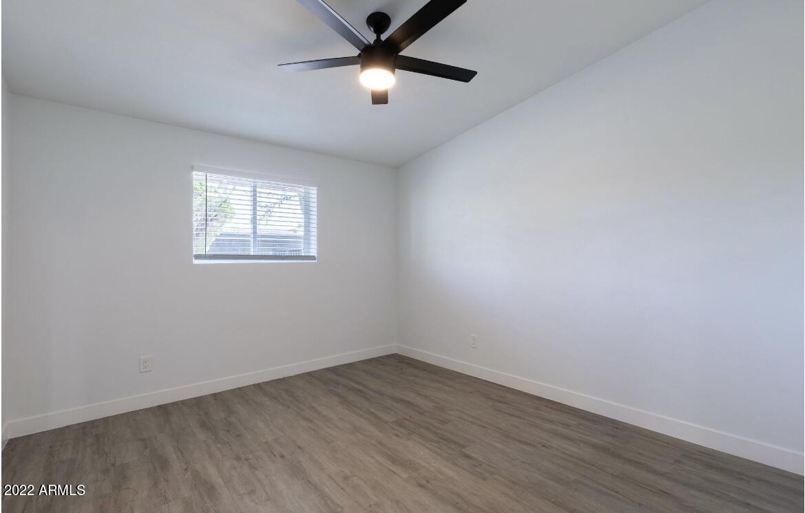 2020 West Hayward Avenue, Unit 31 Phoenix, AZ 85021 - Photo 5 of 13 wooden floor in an empty room with a window