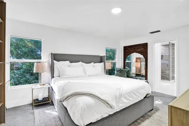 a bedroom with bed and window