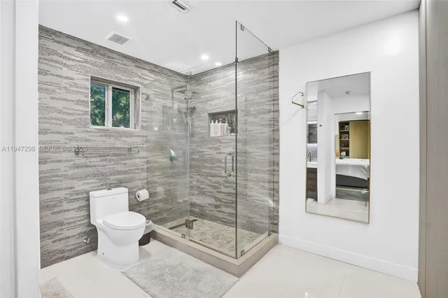 a bathroom with a toilet and a shower