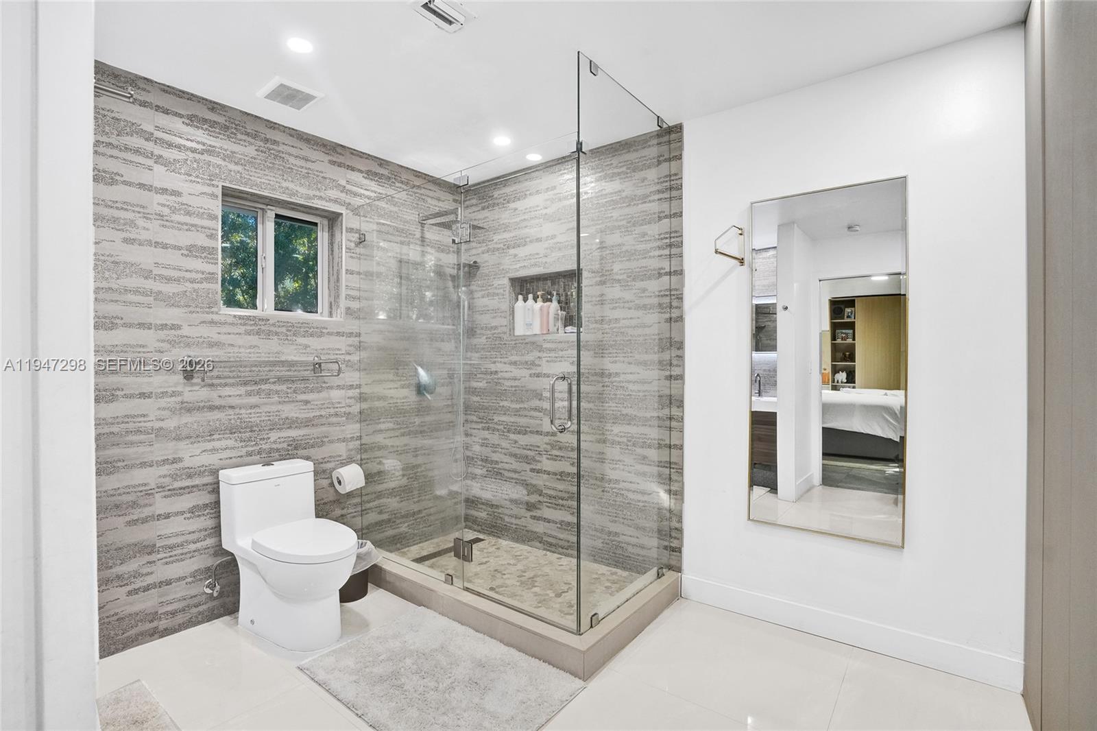 9181 Byron Avenue Surfside, FL 33154 - Photo 19 of 51 a bathroom with a toilet and a shower