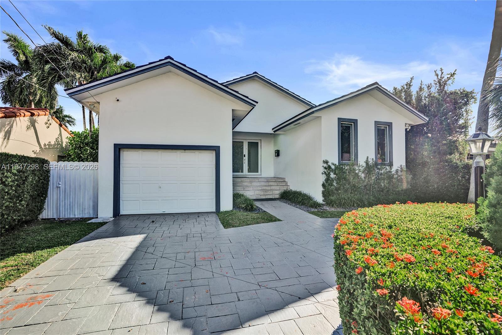 9181 Byron Avenue Surfside, FL 33154 - Photo 2 of 51 a view of a house with yard and plants